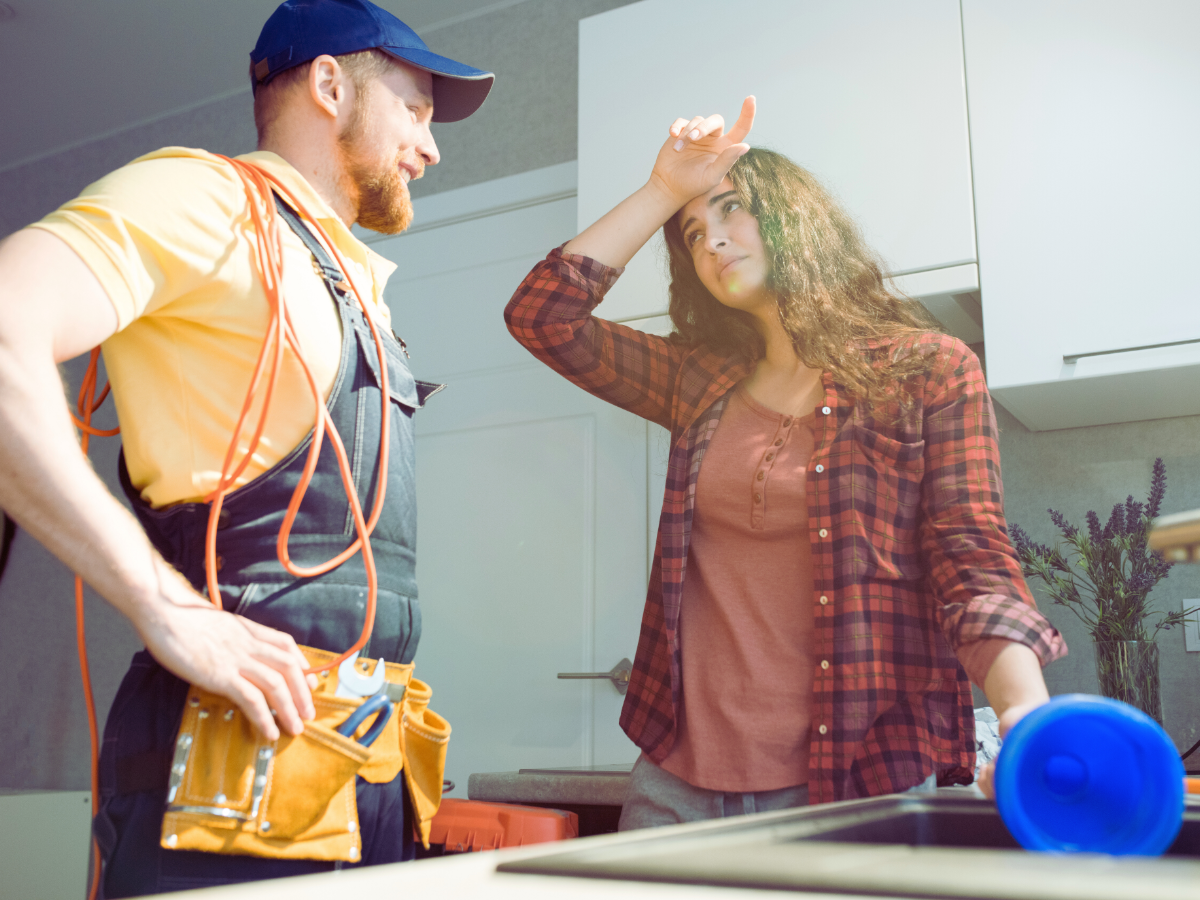 Plumber talking to stressed out homeowner