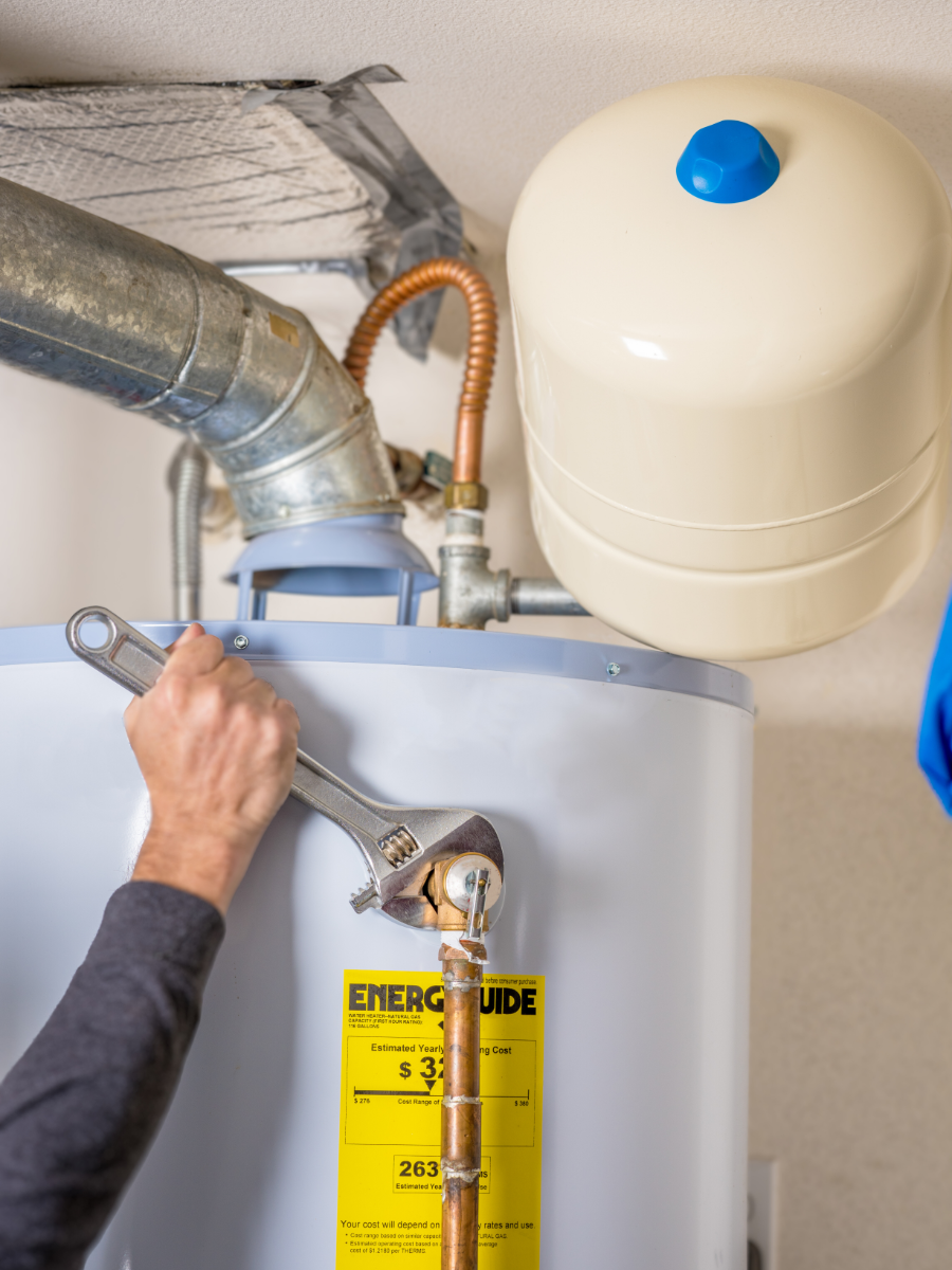 plumber making repairs to make sure water heater is up to code