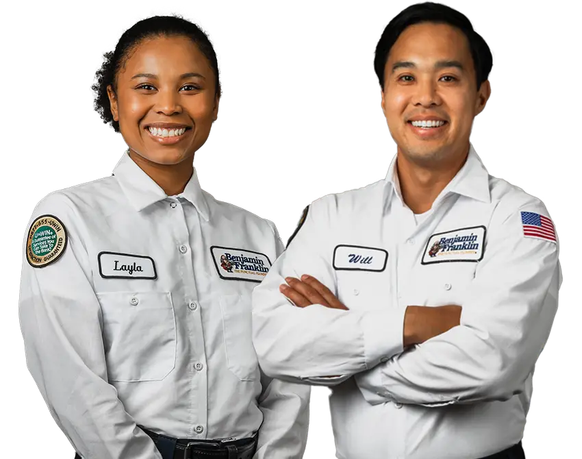 Layla and Will, Benjamin Franklin plumbers in Tampa, standing confidently in uniform.