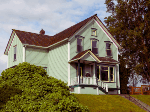 old light teal colored home built in 1950s