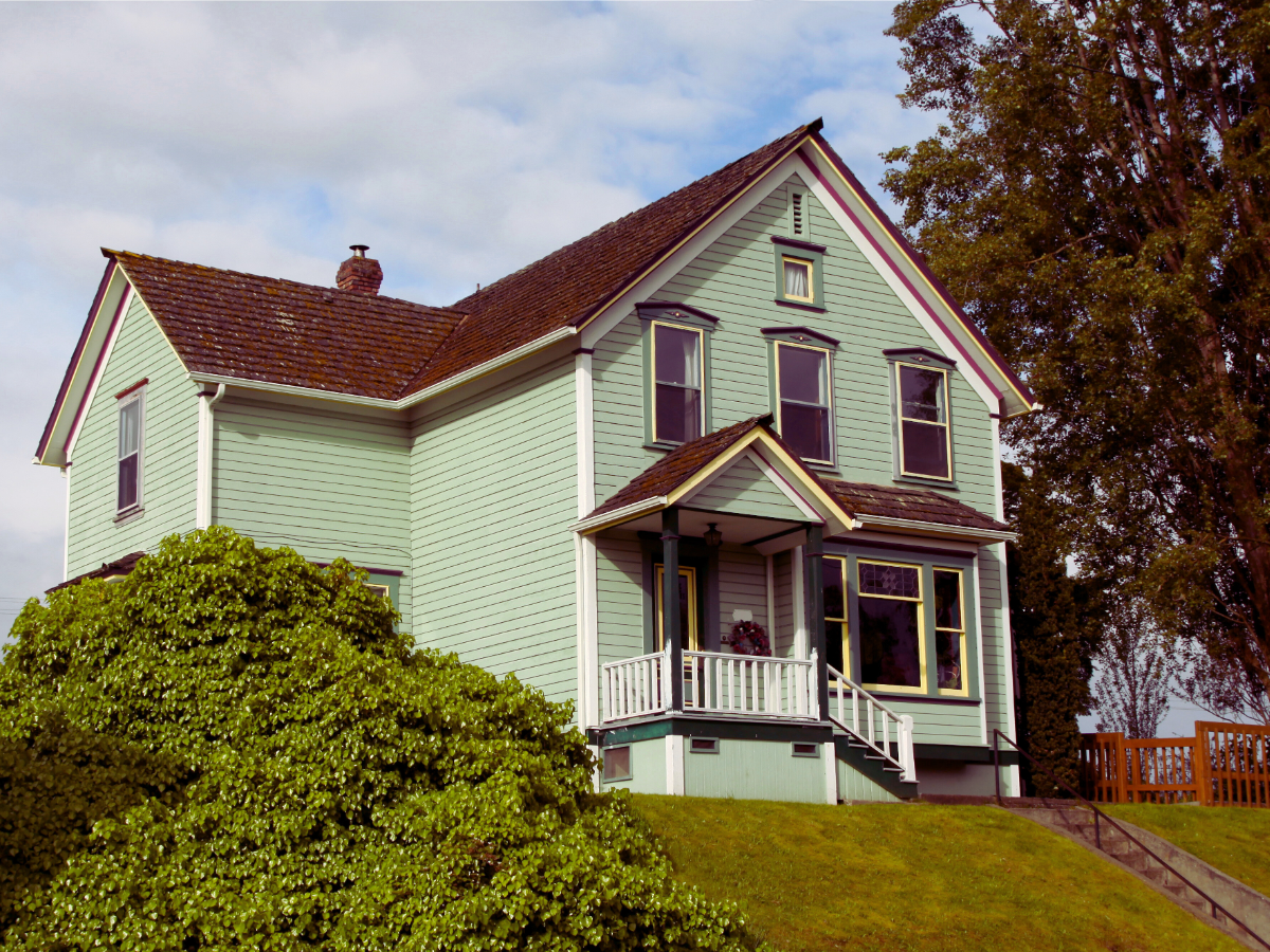 old light teal colored home built in 1950s