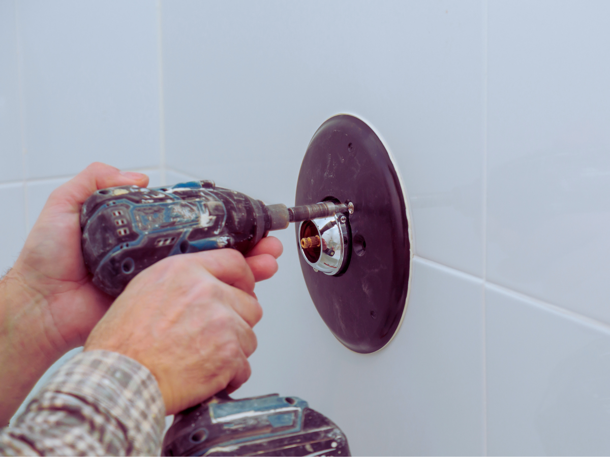 Plumber installing shower mixer